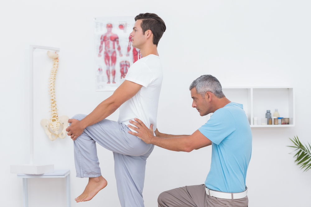 Doctor examining his patient back in medical office